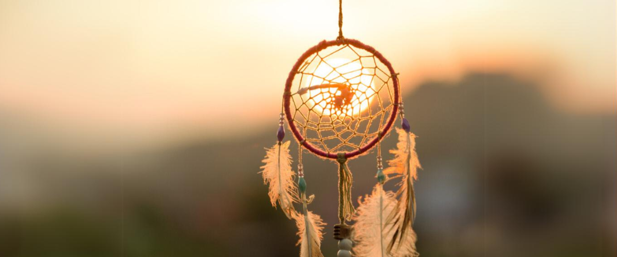 Dream cathcher amulet with sunset in background.