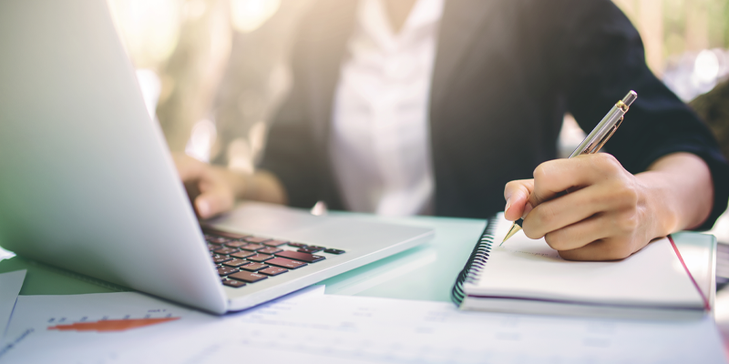 Woman taking notes in an online training