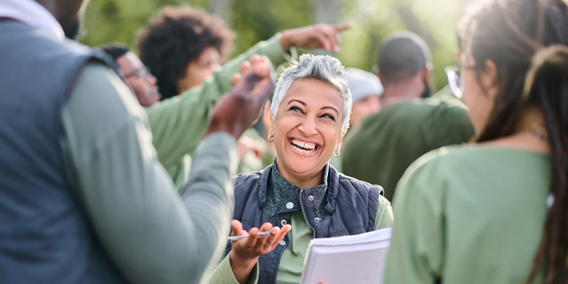 Smiling woman giving instructions to a group of volunteers