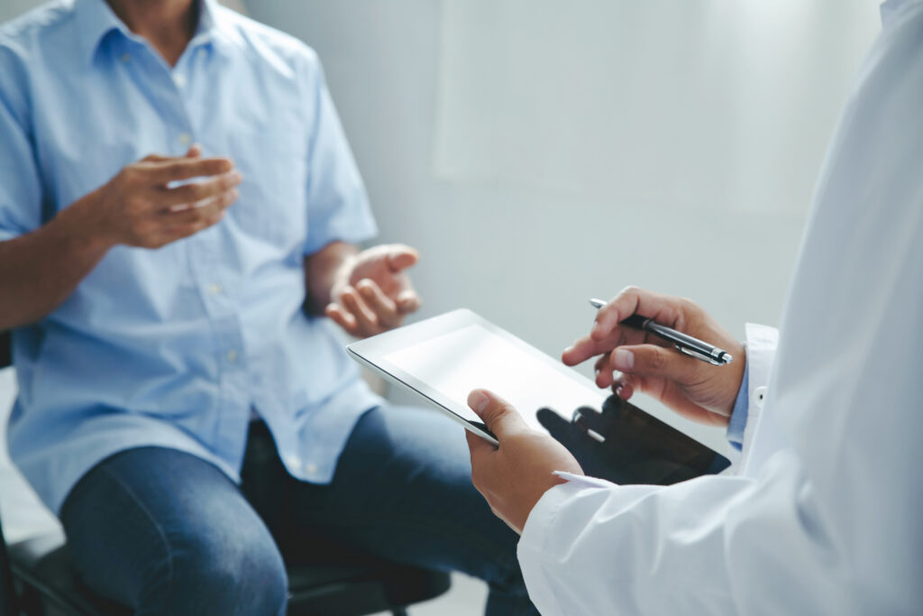 Doctor talking to a patient, explaining the treatment of a patient's illness