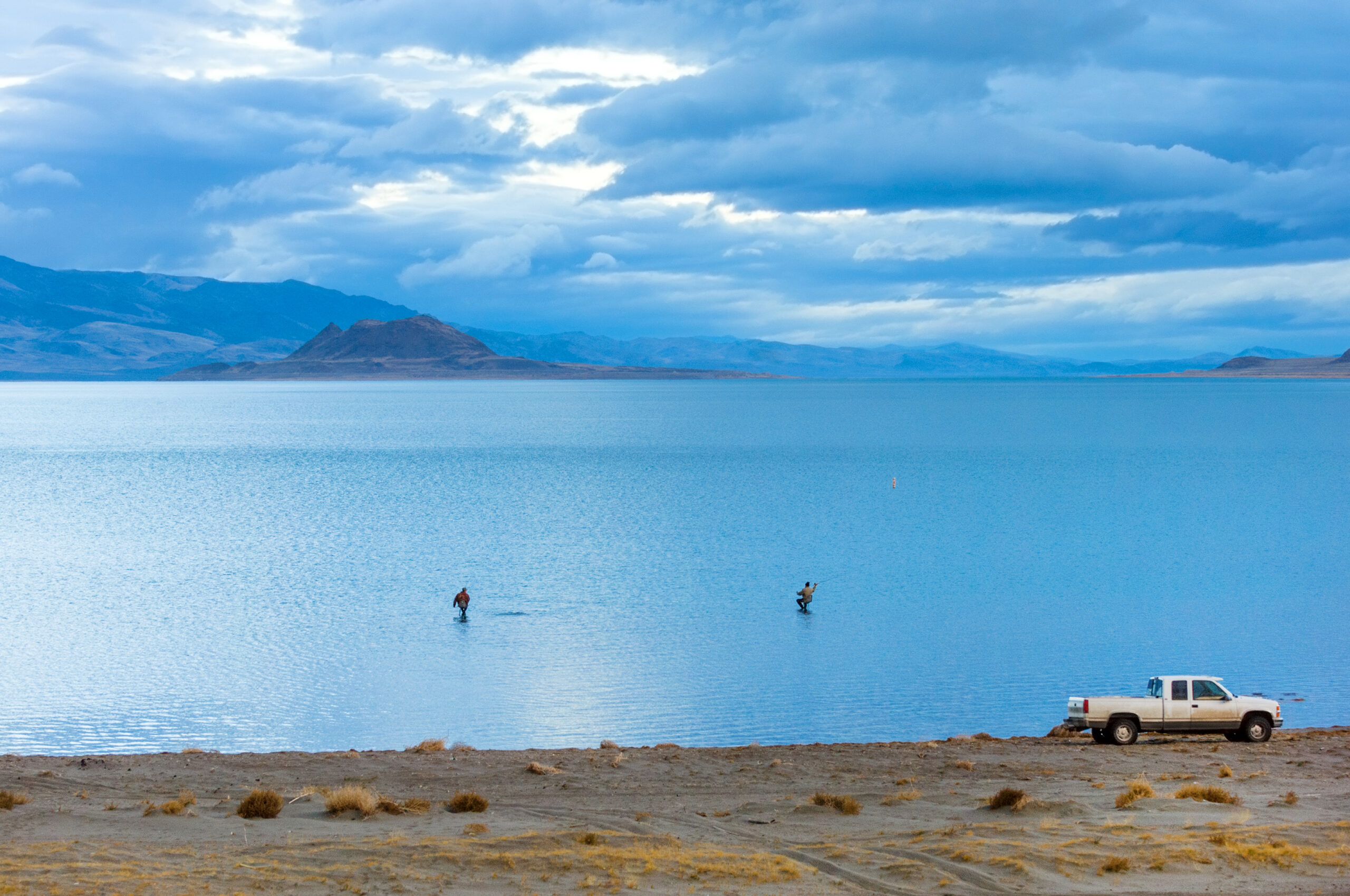 Fishing in calm waters of Pyramid lake in early morning, Nevada, USA