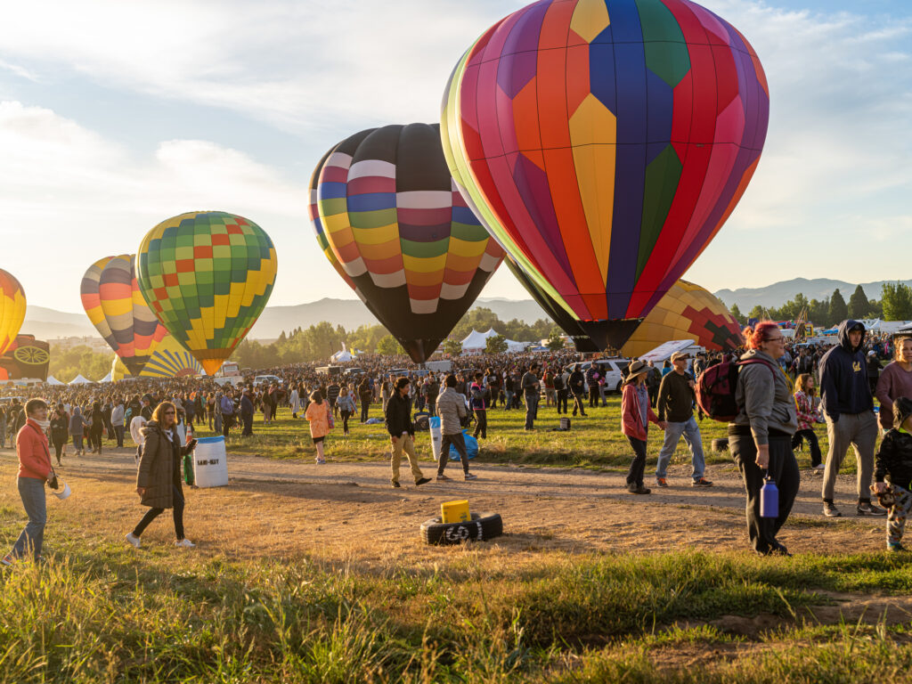 Colorful hot air balloons with spectators at the Reno Balloon Races, a 38 year long tradition.