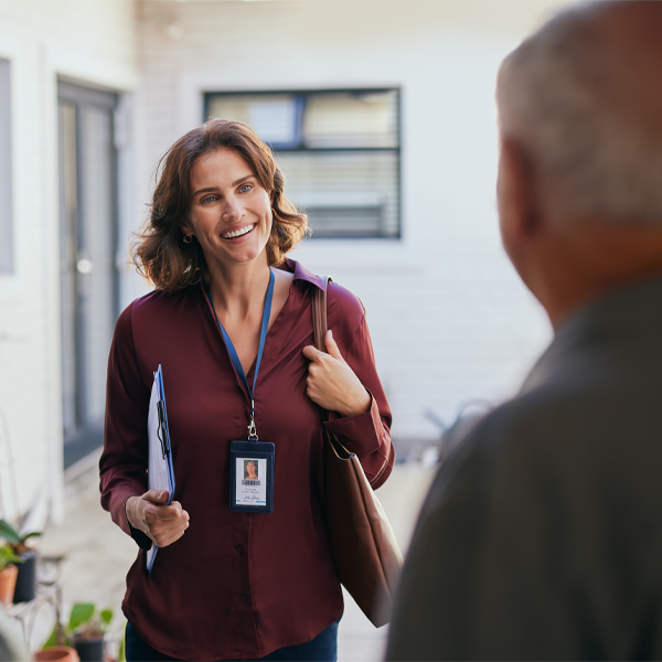 Community health worker greeting an elderly man