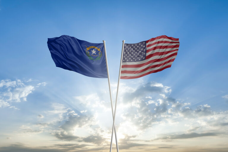 Flags of Nevada state and United states of America together waving in sky