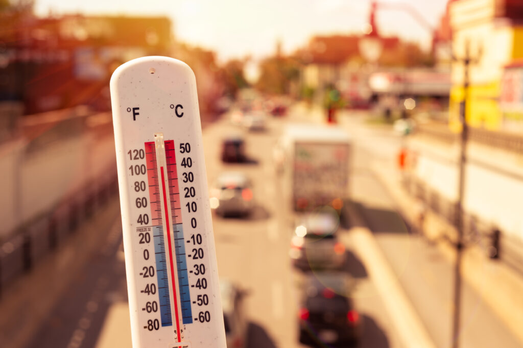 Thermometer in front of cars and traffic during heatwave in Las Vegas.
