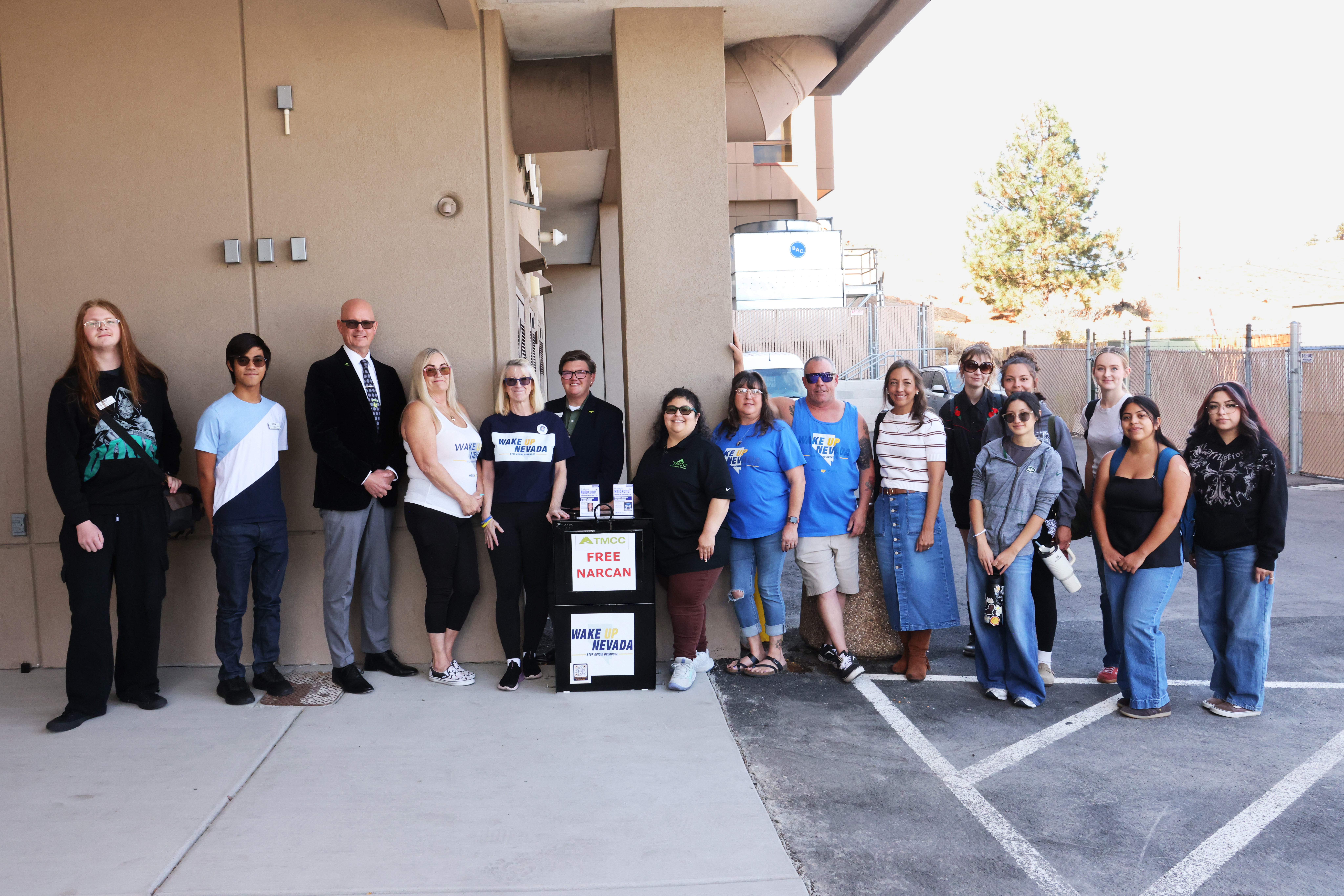 TMCC students, TMCC Counseling Center staff, TMCC's president and staff, CASAT/NOCE staff, and Wake Up Nevada team members gather outside TMCC's Dandini campus around the new free Narcan access box.