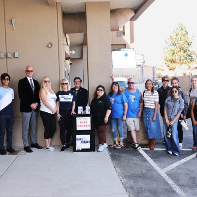 TMCC students, TMCC Counseling Center staff, TMCC's president and staff, CASAT/NOCE staff, and Wake Up Nevada team members gather outside TMCC's Dandini campus around the new free Narcan access box.
