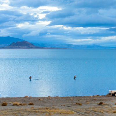 Fishing in calm waters of Pyramid lake in early morning, Nevada, USA