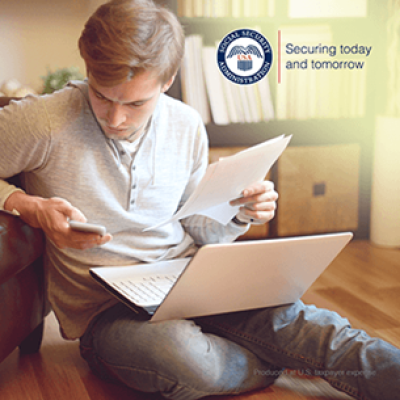 Picture1 : A young man sits on the floor using a laptop, holding papers in one hand and looking at his phone. The logo of the Social Security Administration is shown in the upper right corner with the text “Securing today and tomorrow.” Let me know if you’d like a shorter or more descriptive version!