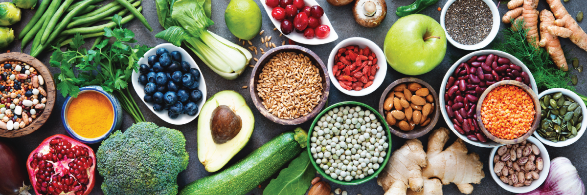 Bountiful display of greens, fruits, and grain.